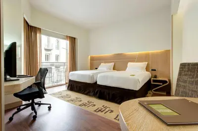 a hotel room with a bed and a desk with a computer at Hilton Garden Inn Rome Claridge in Rome