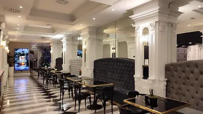 a row of tables and chairs in a restaurant at Radisson Blu GHR Rome in Rome