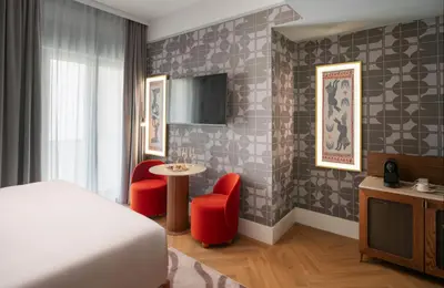 a bedroom with a bed and a table and chairs at NYX Hotel Rome by Leonardo Hotels in Rome