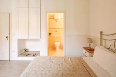a bedroom with a bed and a bathroom at Dante's in Vaticano in Rome