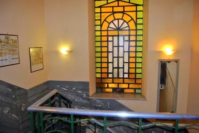 a room with a stained glass window on the wall at Hotel Carmel in Rome