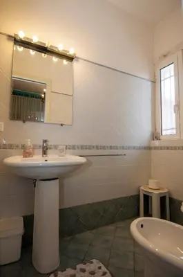 a bathroom with a sink and a mirror and a tub at Passeggiate Romane in Rome