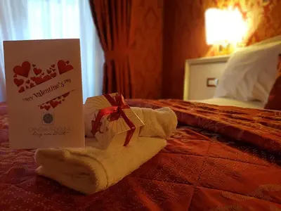 a towel with a card and a box on a bed at Residenza Canova Tadolini - Guesthouse in Rome