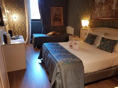 a hotel room with two beds in a room at Residenza Canova Tadolini - Guesthouse in Rome