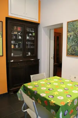 a dining room with a green table and chairs at B&B&Courtesy in Rome