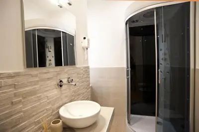 a bathroom with a toilet and a glass shower at Town House 62 in Rome