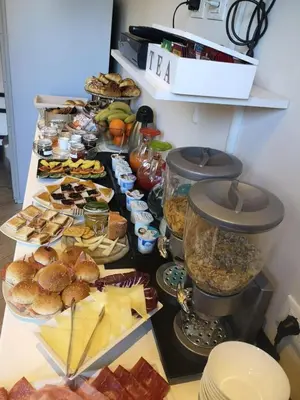a buffet of food on a table with food at Mia Suites in Rome