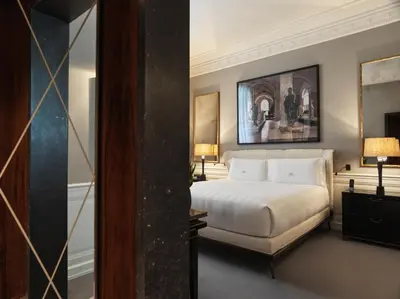 a hotel room with a bed and a mirror at J.K. Place Roma - The Leading Hotels of the World in Rome