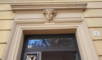 a door with a face on top of it at Campanella3 in Rome