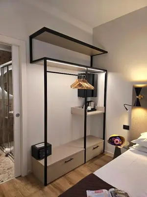 a bedroom with a black and white canopy bed at Hotel Porta Pia in Rome
