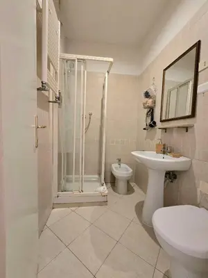 a bathroom with a shower and a toilet and a sink at Hotel Porta Pia in Rome