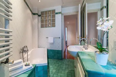 a bathroom with a tub and a sink and a bath tub at HospitalityRome Domus Colosseo in Rome