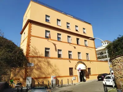 a large yellow building with an arched doorway at Hotel Villa Rosa in Rome