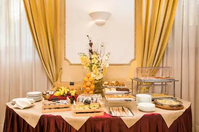 a table with a buffet of food on it at Hotel Villa Rosa in Rome