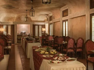 a dining room with tables and chairs with food on them at Palazzo Cardinal Cesi in Rome