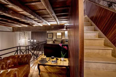 a living room with a couch and a table at The Inn at the Roman Forum Luxury Collection - The Inn At The Roman Forum in Rome