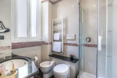 a bathroom with a toilet and a sink and a shower at Hotel Caracciolo in Rome