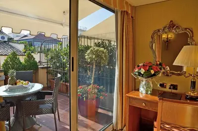 a kitchen with a sliding glass door to a balcony at Hotel Homs in Rome