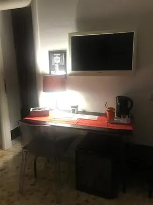 a desk in a room with a television on the wall at Ai Senatori in Rome