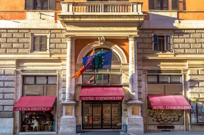 a store front with red awnings on a building at Cosmopolita Rome Colosseum, Tapestry Collection by Hilton in Rome