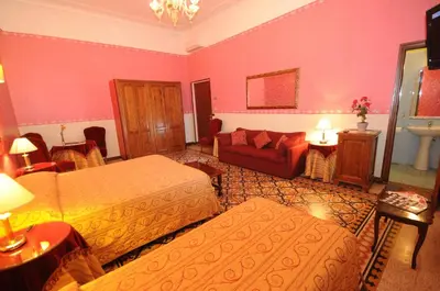 a living room with two beds and a couch at Hotel Sweet Home in Rome