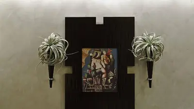 two potted plants on a wall with a picture at Intown Luxury House in Rome