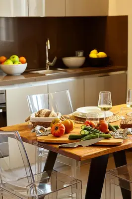 a wooden table with tomatoes and vegetables on it at Trianon Borgo Pio Aparthotel in Rome
