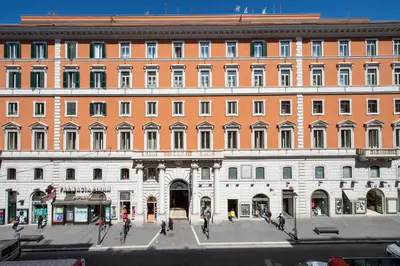 a large building with people walking in front of it at Domus Livia in Rome