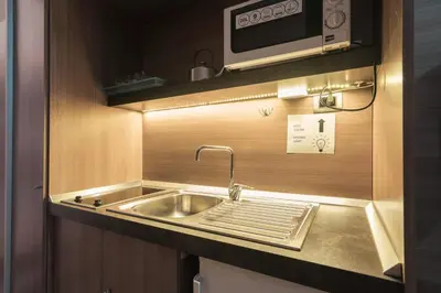 a kitchen with a sink and a microwave at Residence Europa in Rome