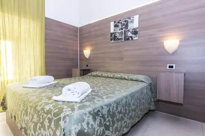 a bedroom with a bed with towels on it at Residence Europa in Rome