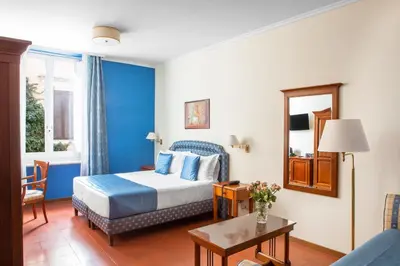 a hotel room with a bed and a table at Hotel Piazza Di Spagna in Rome