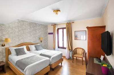 a hotel room with two beds and a television at Hotel Piazza Di Spagna in Rome
