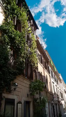 a building with plants growing on the side of it at Hotel Piazza Di Spagna in Rome