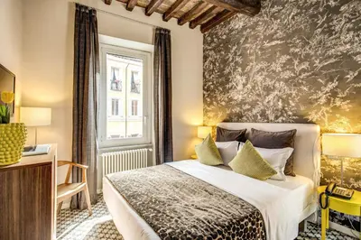 a bedroom with a bed and a wall mural at Trevi Beau Boutique Hotel in Rome