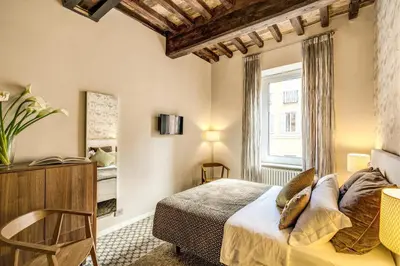a bedroom with a bed and a window at Trevi Beau Boutique Hotel in Rome