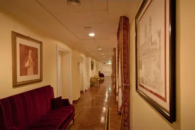 a hallway with a couch and pictures on the wall at Residenza Paolo VI in Rome