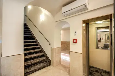 a staircase in a house with a mirror at Hotel San Silvestro in Rome