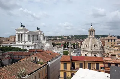 a view of a city with roofs and buildings at Hotel Traiano in Rome