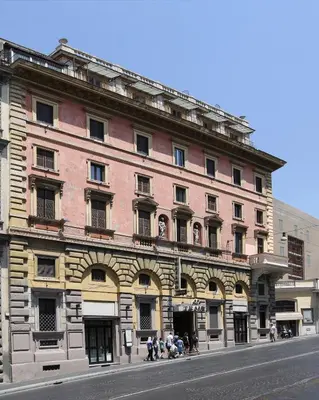 a large brick building on the side of a street at Hotel Traiano in Rome