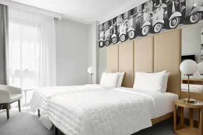 a hotel room with a large bed and a desk at Le Meridien Visconti Rome in Rome