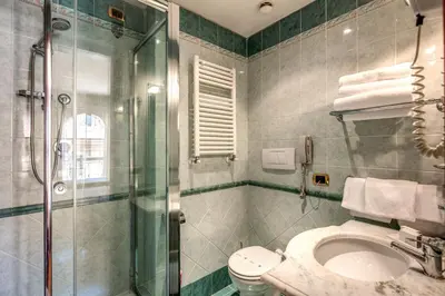 a bathroom with a shower and a toilet and a sink at Hotel Villafranca in Rome