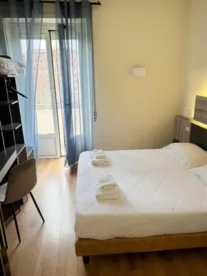 a bedroom with a bed with two towels on it at Hotel Laura in Rome