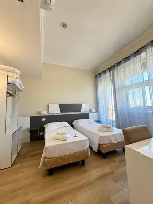 a hospital room with two beds and a kitchen at Hotel Laura in Rome