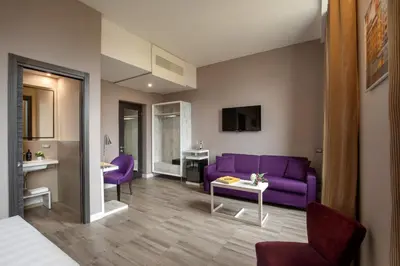 a living room with a purple couch and a table at The Guardian in Rome
