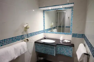 a bathroom with a sink and a mirror at Hotel Canova in Rome