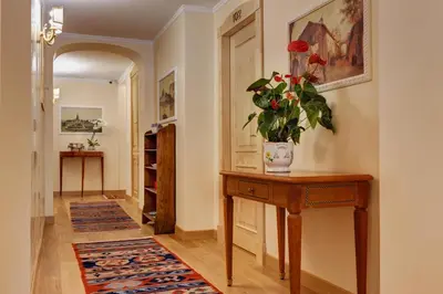 a hallway with a table with a vase of flowers on it at Residenza RomaCentro in Rome