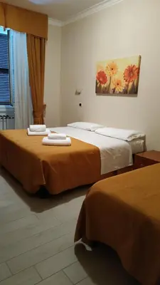 two beds in a hotel room with towels on them at Hotel Everest in Rome