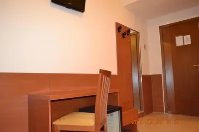 a wooden table with a wooden chair and a desk at Hotel Everest in Rome