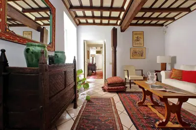 a living room with a table and a couch at Sangallo Charme in Rome