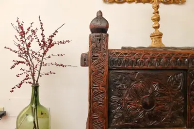 a vase sitting next to a wooden table with a bottle at Sangallo Charme in Rome